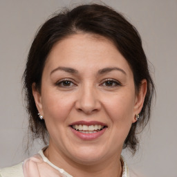 Joyful white adult female with medium  brown hair and brown eyes