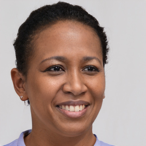 Joyful black young-adult female with short  brown hair and brown eyes