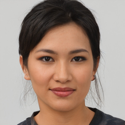 Joyful asian young-adult female with medium  brown hair and brown eyes
