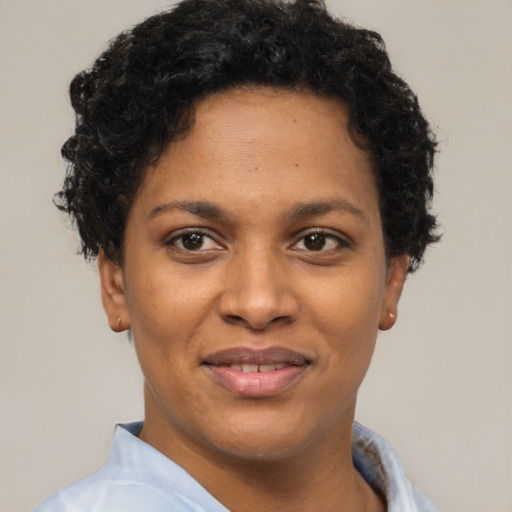 Joyful black young-adult female with short  black hair and brown eyes