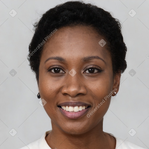 Joyful black young-adult female with short  black hair and brown eyes