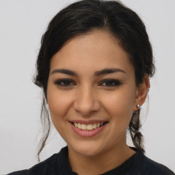 Joyful latino young-adult female with long  brown hair and brown eyes