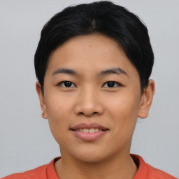 Joyful asian young-adult female with short  black hair and brown eyes