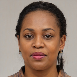 Joyful black adult female with medium  brown hair and brown eyes