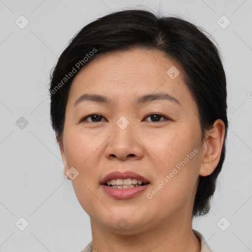 Joyful asian adult female with medium  brown hair and brown eyes