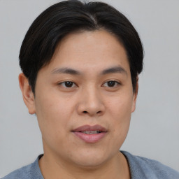 Joyful asian young-adult male with short  brown hair and brown eyes