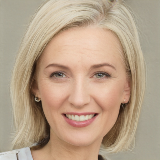 Joyful white young-adult female with medium  blond hair and brown eyes