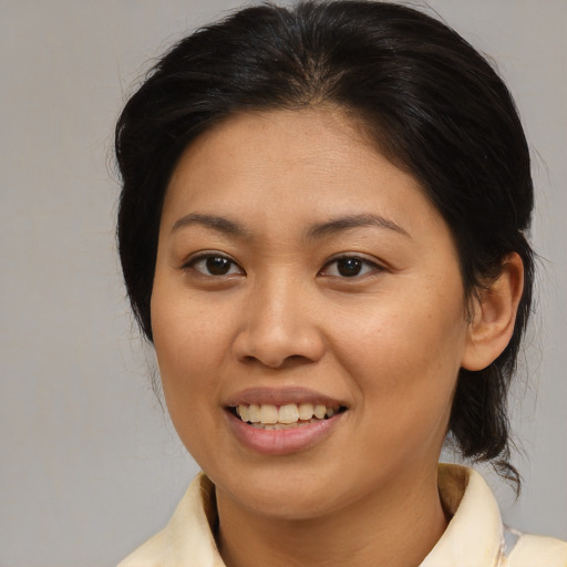 Joyful latino young-adult female with medium  brown hair and brown eyes