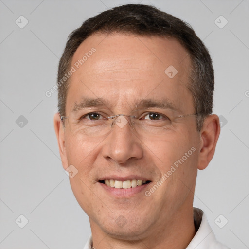 Joyful white adult male with short  brown hair and brown eyes