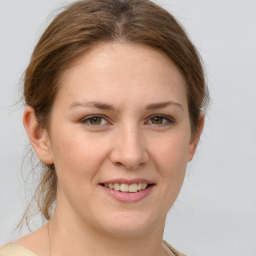 Joyful white young-adult female with medium  brown hair and green eyes