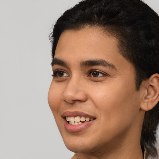 Joyful latino young-adult male with short  brown hair and brown eyes