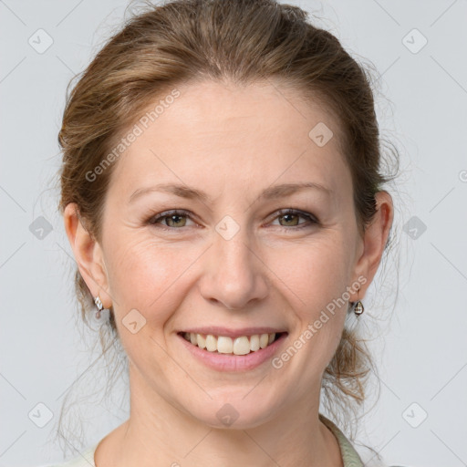 Joyful white adult female with medium  brown hair and grey eyes