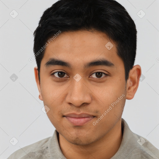 Joyful latino young-adult male with short  black hair and brown eyes