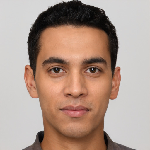 Joyful white young-adult male with short  black hair and brown eyes