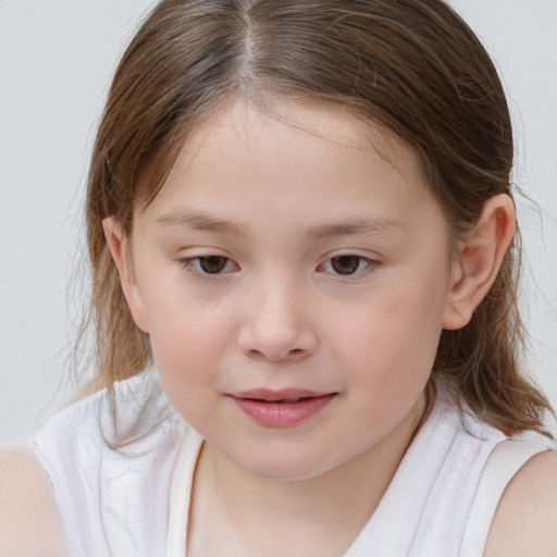 Joyful white child female with medium  brown hair and brown eyes