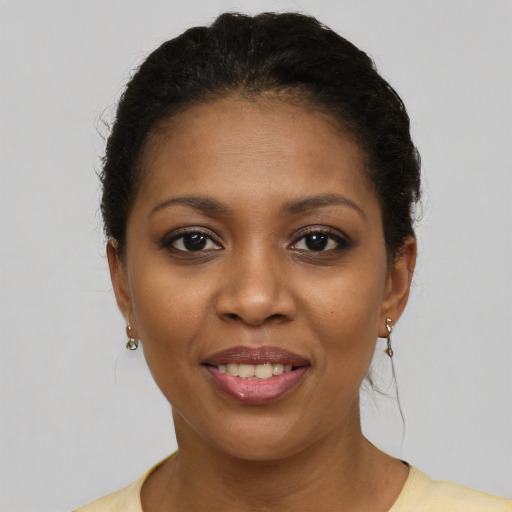 Joyful black young-adult female with short  brown hair and brown eyes