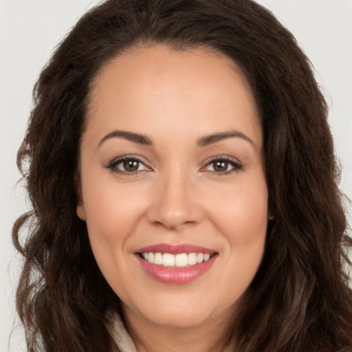 Joyful white young-adult female with long  brown hair and brown eyes