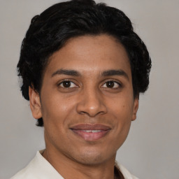 Joyful latino young-adult male with short  brown hair and brown eyes