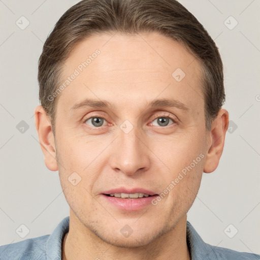 Joyful white young-adult male with short  brown hair and grey eyes