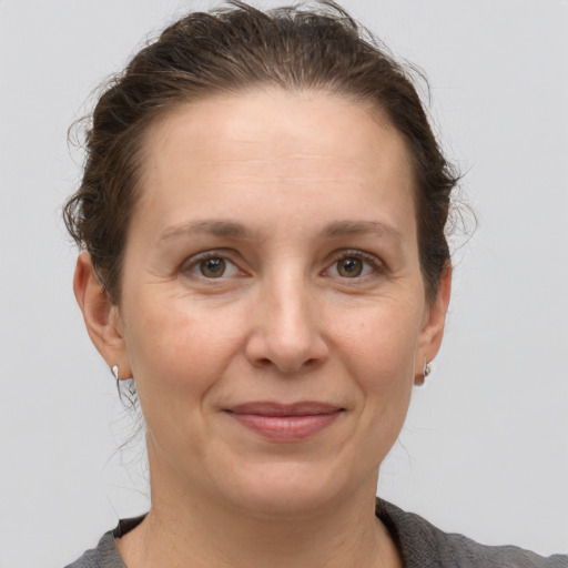 Joyful white adult female with short  brown hair and grey eyes