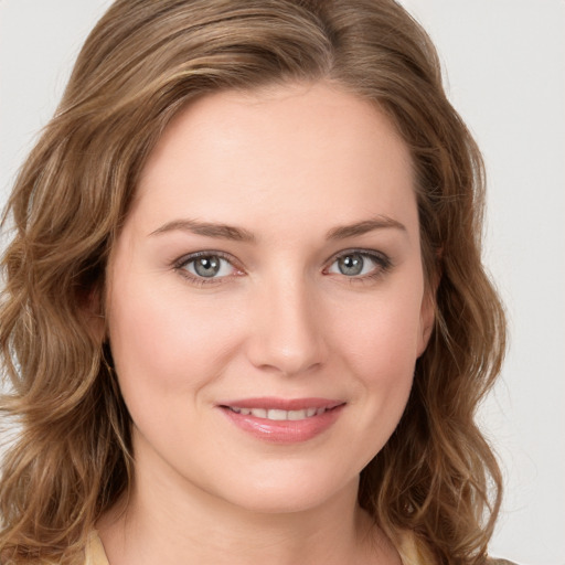 Joyful white young-adult female with long  brown hair and green eyes