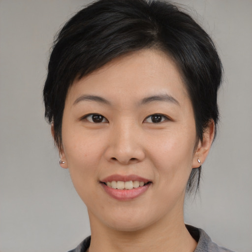 Joyful asian young-adult female with medium  black hair and brown eyes