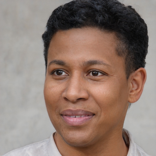 Joyful latino adult male with short  black hair and brown eyes