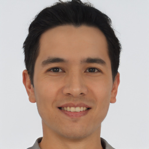 Joyful asian young-adult male with short  black hair and brown eyes