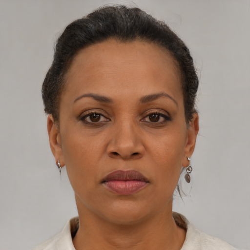 Joyful latino adult female with short  brown hair and brown eyes