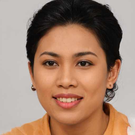 Joyful asian young-adult female with medium  brown hair and brown eyes