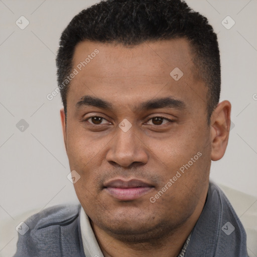 Joyful latino young-adult male with short  black hair and brown eyes