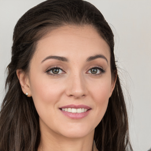 Joyful white young-adult female with long  brown hair and grey eyes