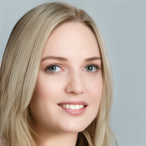 Joyful white young-adult female with long  blond hair and blue eyes