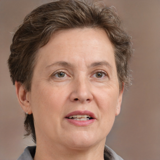 Joyful white adult female with short  brown hair and grey eyes