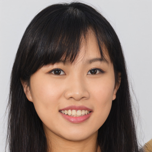 Joyful asian young-adult female with long  brown hair and brown eyes