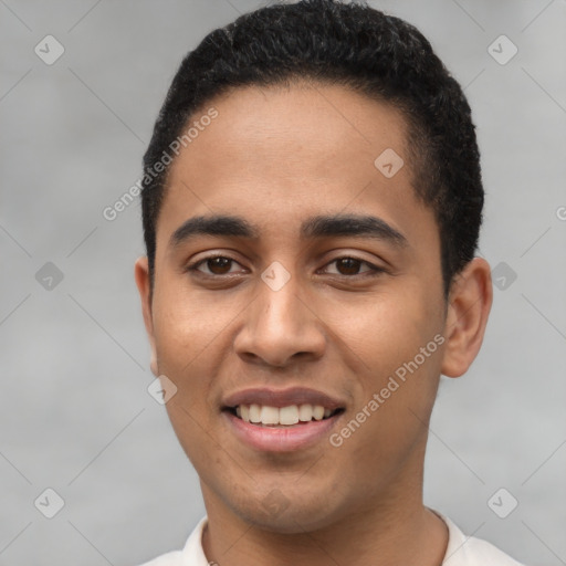 Joyful latino young-adult male with short  black hair and brown eyes