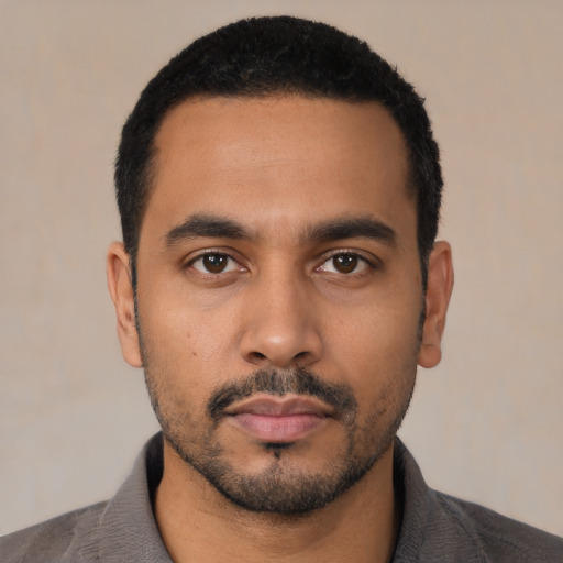 Neutral latino young-adult male with short  black hair and brown eyes