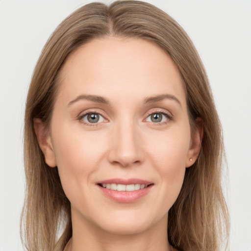 Joyful white young-adult female with long  brown hair and grey eyes