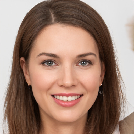 Joyful white young-adult female with long  brown hair and grey eyes