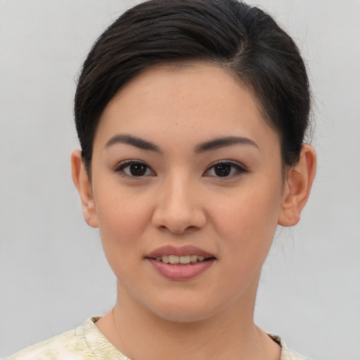 Joyful asian young-adult female with short  brown hair and brown eyes