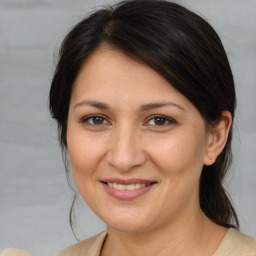 Joyful white adult female with medium  brown hair and brown eyes