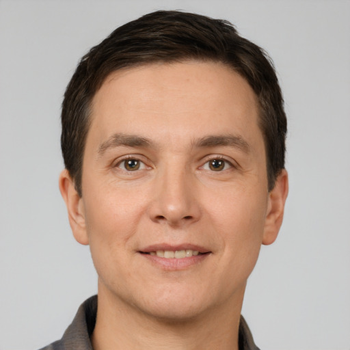 Joyful white young-adult male with short  brown hair and brown eyes