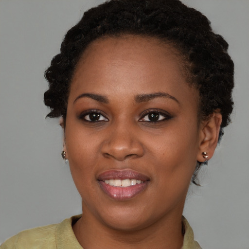 Joyful black young-adult female with short  brown hair and brown eyes