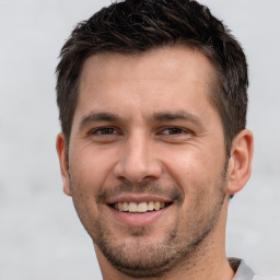 Joyful white young-adult male with short  brown hair and brown eyes