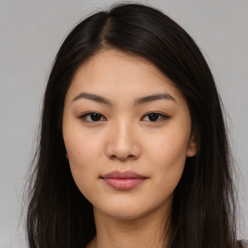 Joyful asian young-adult female with long  brown hair and brown eyes