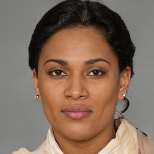 Joyful latino young-adult female with short  black hair and brown eyes
