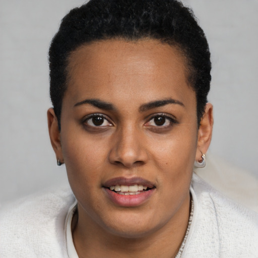 Joyful black young-adult female with short  brown hair and brown eyes