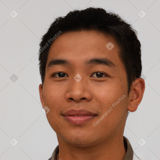 Joyful asian young-adult male with short  brown hair and brown eyes