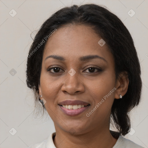 Joyful black adult female with medium  brown hair and brown eyes