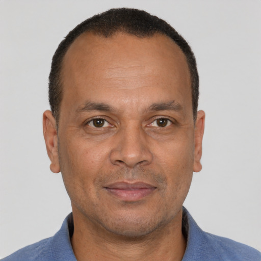 Joyful latino adult male with short  brown hair and brown eyes